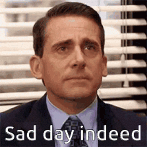 Michael Scott From The Office Is Wearing A Suit And Tie And Looking Sad . GIF