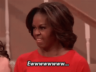 Michelle Obama Smiling in Red Shirt