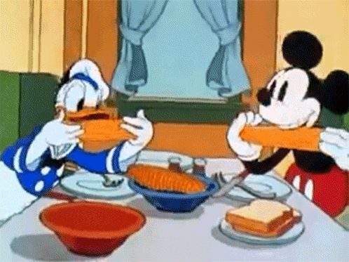 Mickey Mouse And Donald Duck Are Sitting At A Table Eating Sandwiches GIF