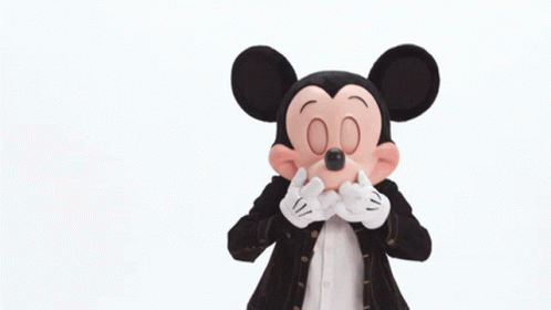 Mickey Mouse Is Wearing A Black Jacket And Red Shorts GIF