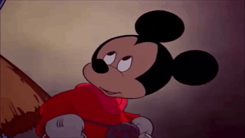 mickey mouse is wearing a red jacket and gloves and looking at something .
