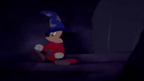 mickey mouse is wearing a wizard hat and red pants