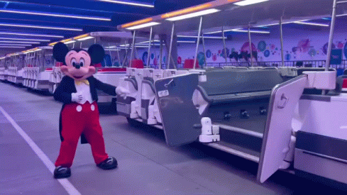 Mickey Mouse Mascot in Front of Train