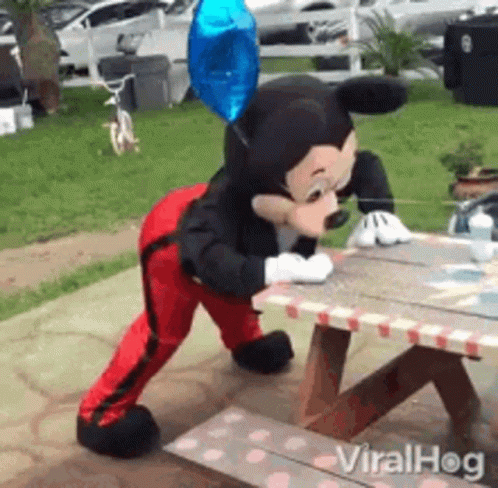 Mickey Mouse Mascot Standing On Picnic Table GIF