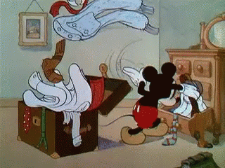 Mickey Mouse Next to Trunk With Clothes