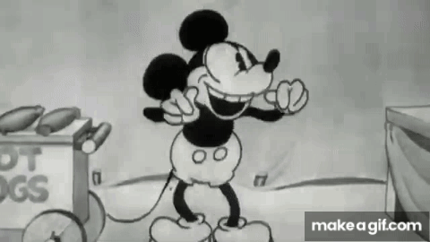 Mickey Mouse Standing in Front of Hot Dog Cart