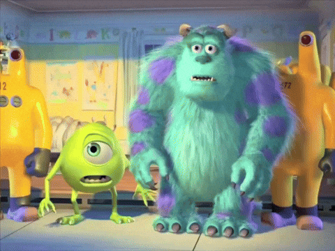 Mike And Sully From Monsters Inc Are Standing Next To Each Other In A Room GIF