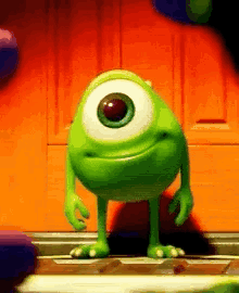 Mike Wazowski From Monsters Inc Is Standing In Front Of A Door . GIF