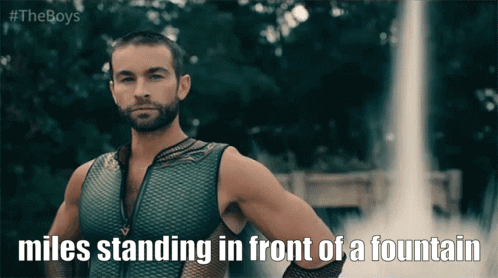 Miles Standing In Front Of Fountain GIF