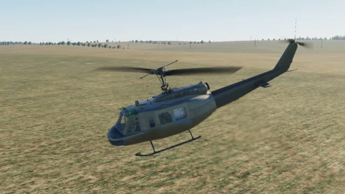 Military Helicopter Flying Over Grassy Field