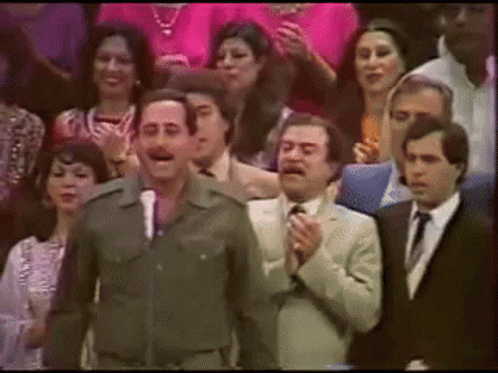 Military Man at Microphone Facing Crowd