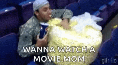 Military Man Eating Popcorn And Drinking Soda In Theater GIF