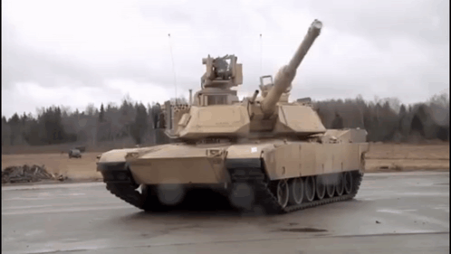 Military Tank Driving on Road with Trees