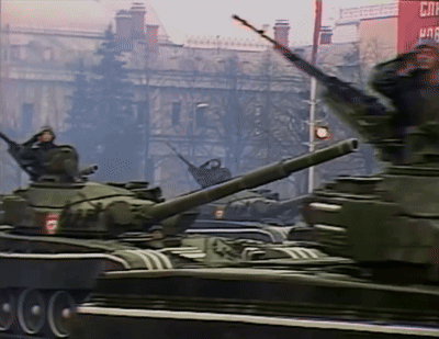 Military Tanks Driving Past Red CNN Building