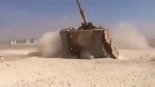 Military Vehicle Driving Through Desert