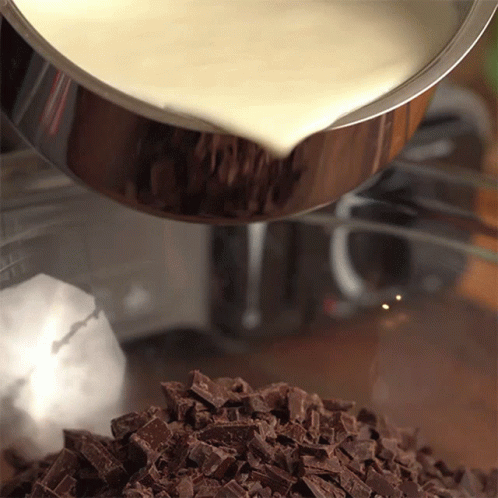Milk Is Being Poured Into A Bowl Of Chocolate GIF