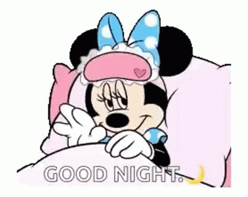 Minnie Mouse Is Laying In A Bed Wearing A Sleep Mask And Saying Good Night . GIF