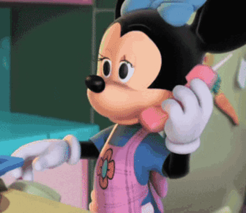 Minnie Mouse Is Talking On A Pink Phone With A Flower On Her Apron GIF