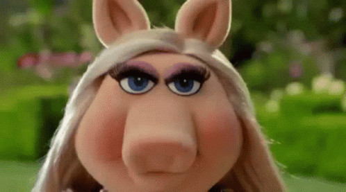 Miss Piggy From The Muppet Show Is Making A Funny Face With Her Eyes Closed . GIF