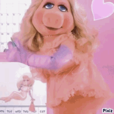 Miss Piggy From The Muppets Is Wearing A Pink Dress And Gloves And Is Standing In Front Of A Calendar . GIF