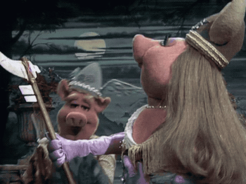 Miss Piggy Is Wearing A Purple Glove While Holding A Cane GIF