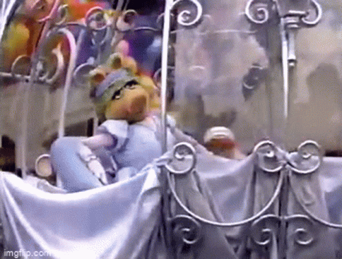 Miss Piggy Riding in Carriage With Cartoon Characters