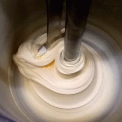 Mixer Mixing White Substance In Container GIF