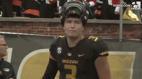 Mizzou Football Player in Helmet by Brick Wall