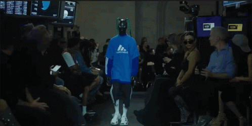 Model Walking Down Runway In Blue Adidas Sweatshirt GIF