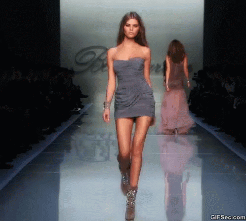 Model Walking Runway in Grey Dress