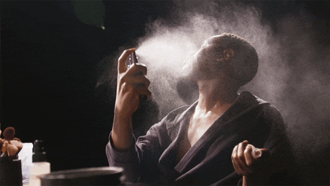 Modelo Spraying Perfume All Over Face GIF