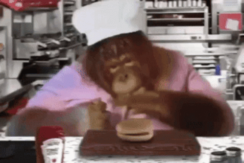 Monkey Chef Eating Hamburger