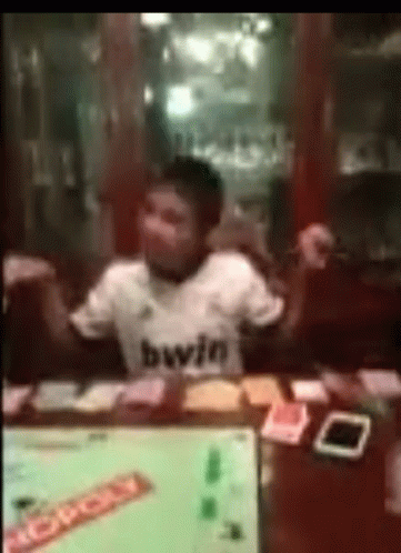 Monopoly Money In Front Of Young Boy GIF