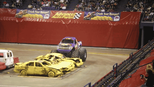 Monster Truck Driving Through Wrecked Cars at Advance Auto Parts