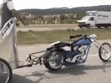 Motorcycle Pulled by Trailer on Side of Road