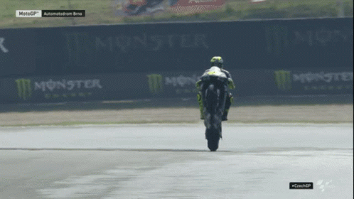 Motorcycle Racer Doing Trick on Track With Monster Energy Signs