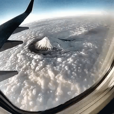 Mountain View From Airplane Window With Clouds GIF