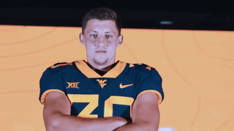 Mountaineers Player Crossing Arms For Pose GIF