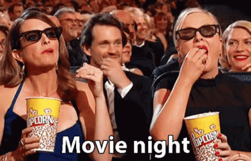 Moviegoers Eating Popcorn In 3D Glasses GIF