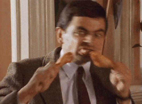 Mr. Bean Eating Chicken Wing GIF