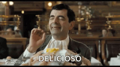 Mr Bean Eating Hamburger at Table