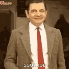 Mr Bean In Suit And Tie Smiling Saying Good Job GIF