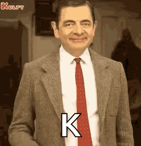 Mr Bean in Suit and Tie With Letter K on Chest