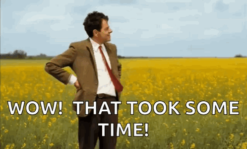 Mr Bean Is Standing In A Field Of Yellow Flowers . GIF
