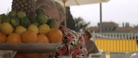 Mrs Doubtfire Peeking Behind Fruits GIF