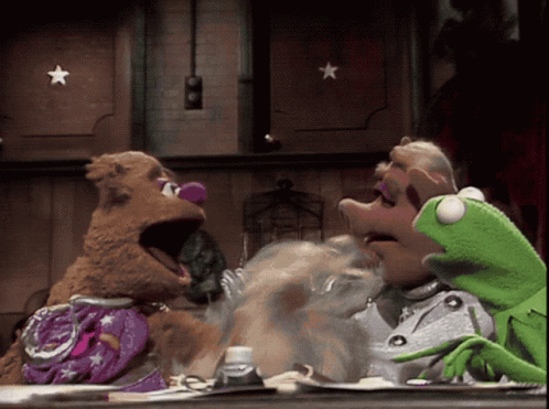 Mrs. Piggy And Kermit Sitting At Table GIF