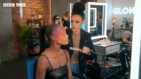 Mua Puts Face Paint Walking On Model GIF