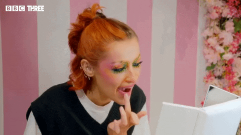 Mua Puts Lipstick Using Hands GIF