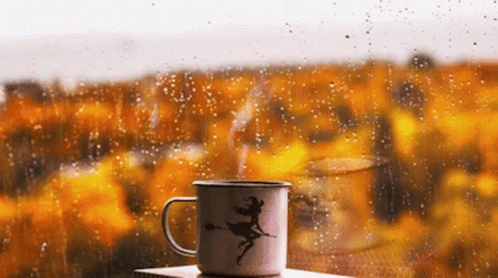 Mug With Witch In Front Of Rainy Window GIF