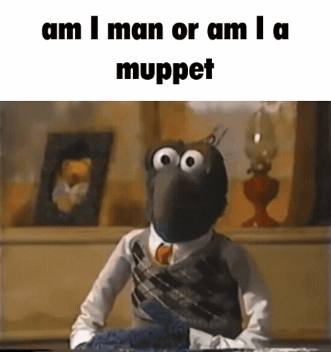 Muppet in Suit and Tie Sitting at Table